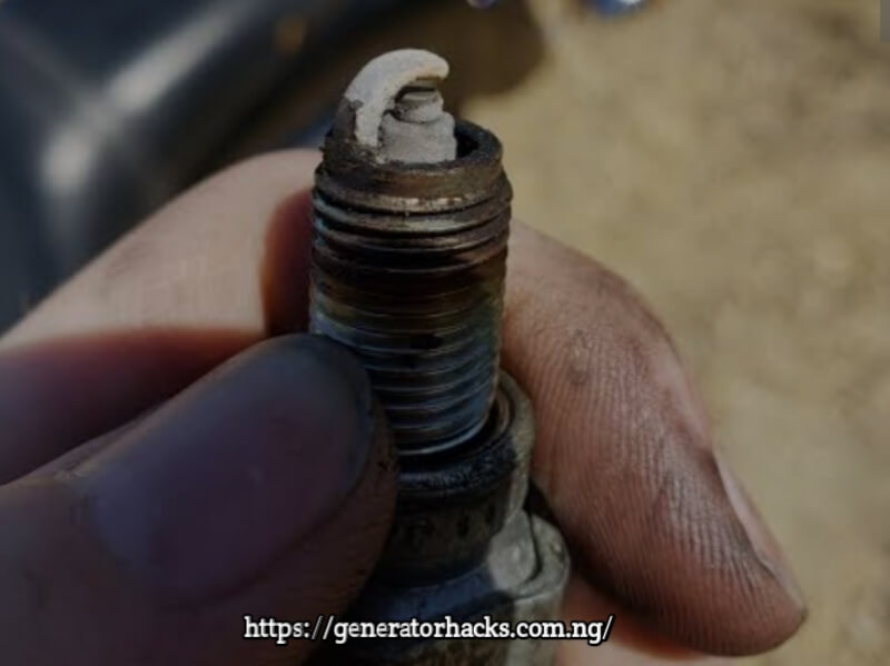 Man holding spark plug tips white 